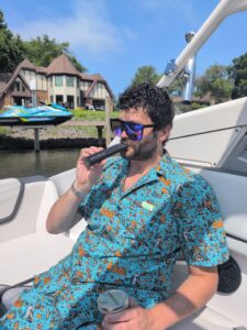 man in a blue decorative outfit using Mixturus dry botanical vaporizer
